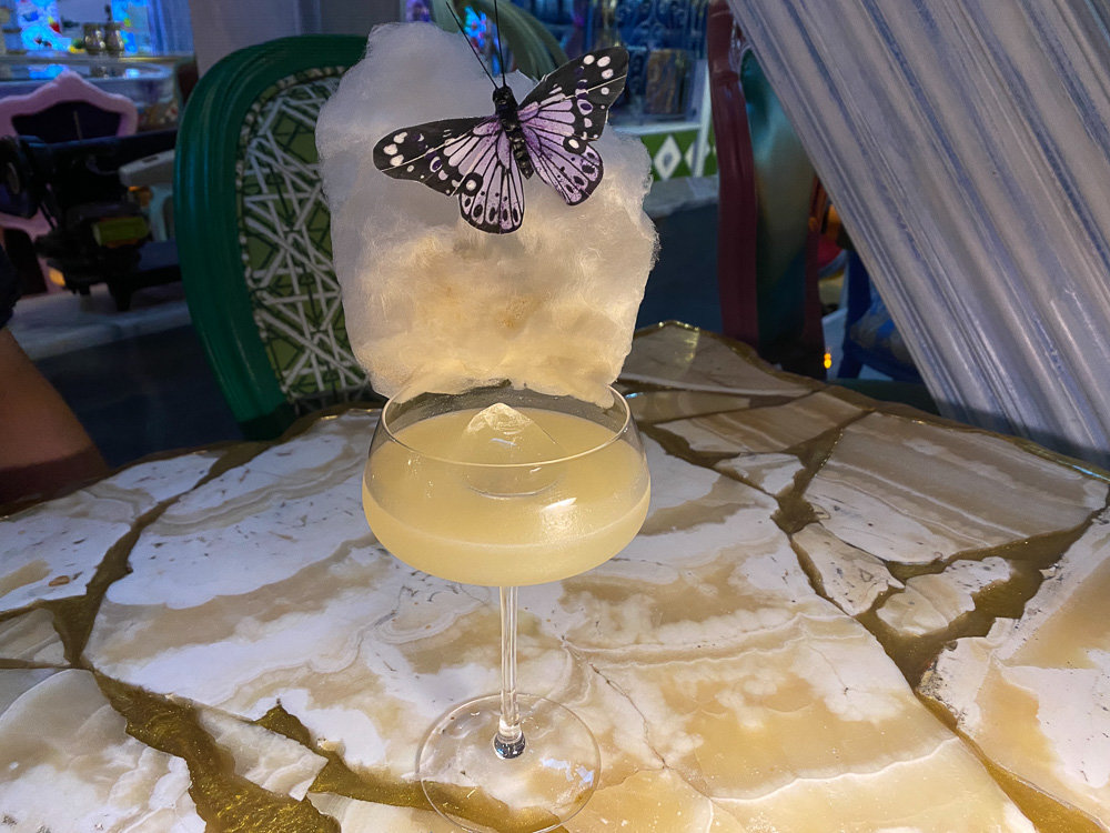 cocktail with cotton candy and butterfly decoration